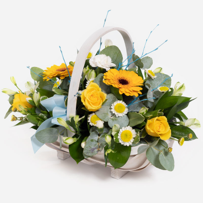 Blue Baby Boy Basket - A floral basket overflowing with yellow and white flowers, neatly arranged with foliage. 
